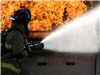 Firefighter Hosing Down Fire
