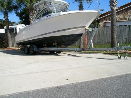 A large boat is parked in a residential area against code.