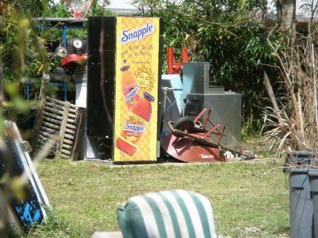 Large piles of junk are visible on personal property.